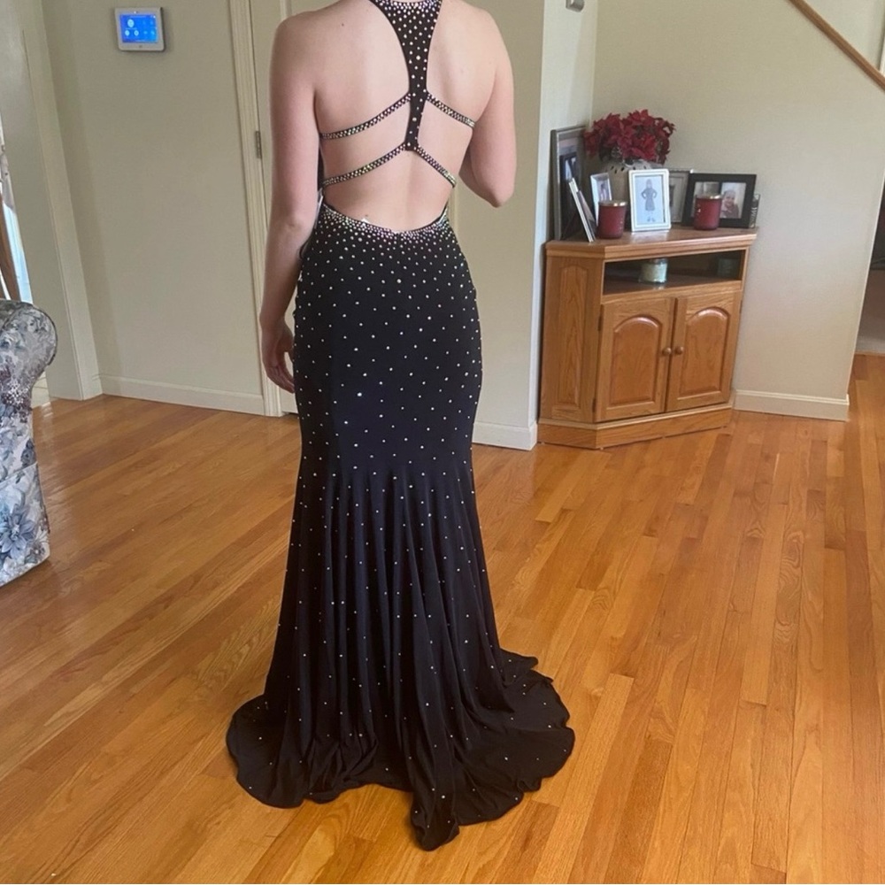 Jovani Black Backless Gown with Silver Accents
Bought for prom never worn.